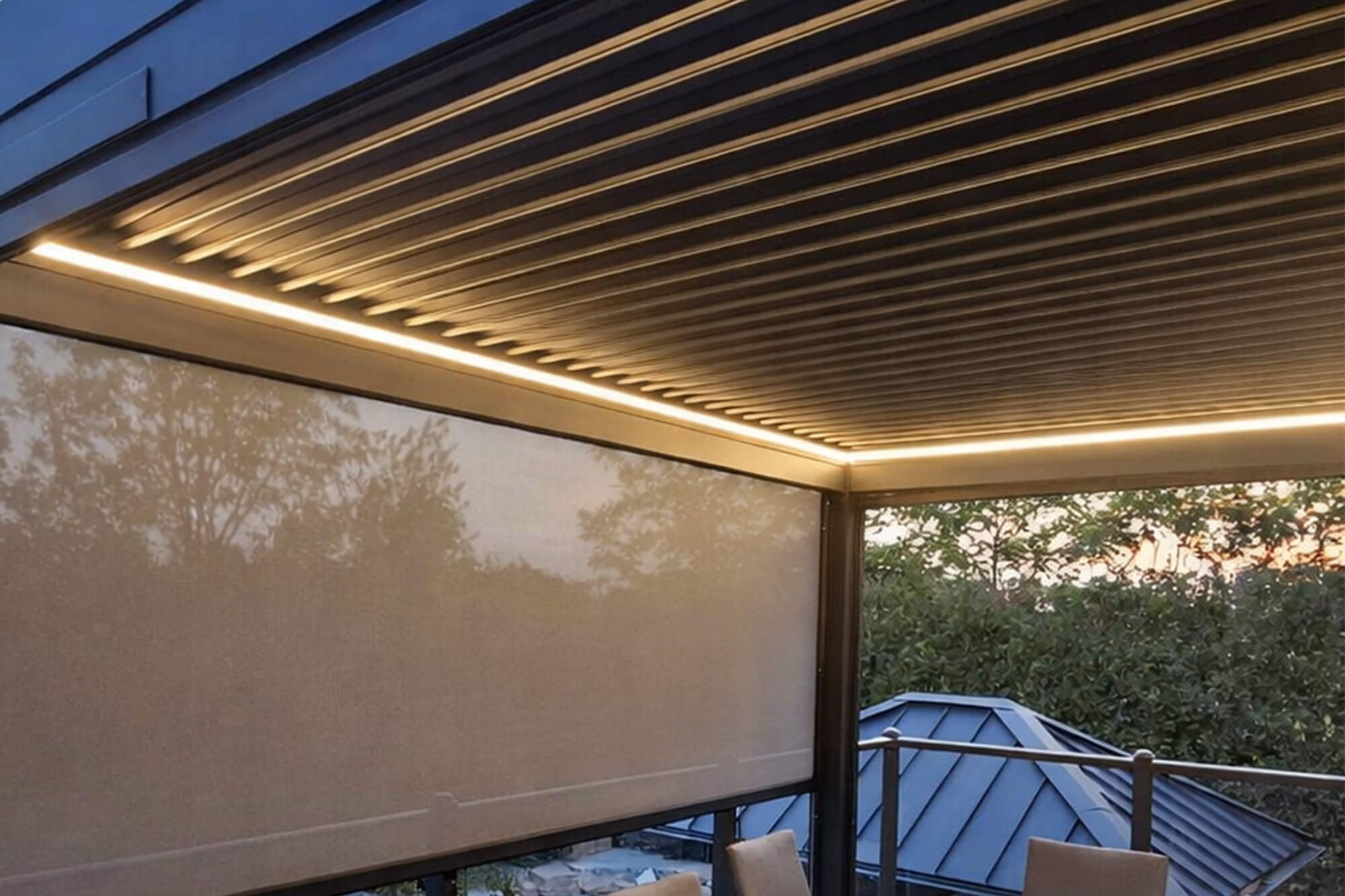 Integrated LED lighting under a louvered pergola in the evening