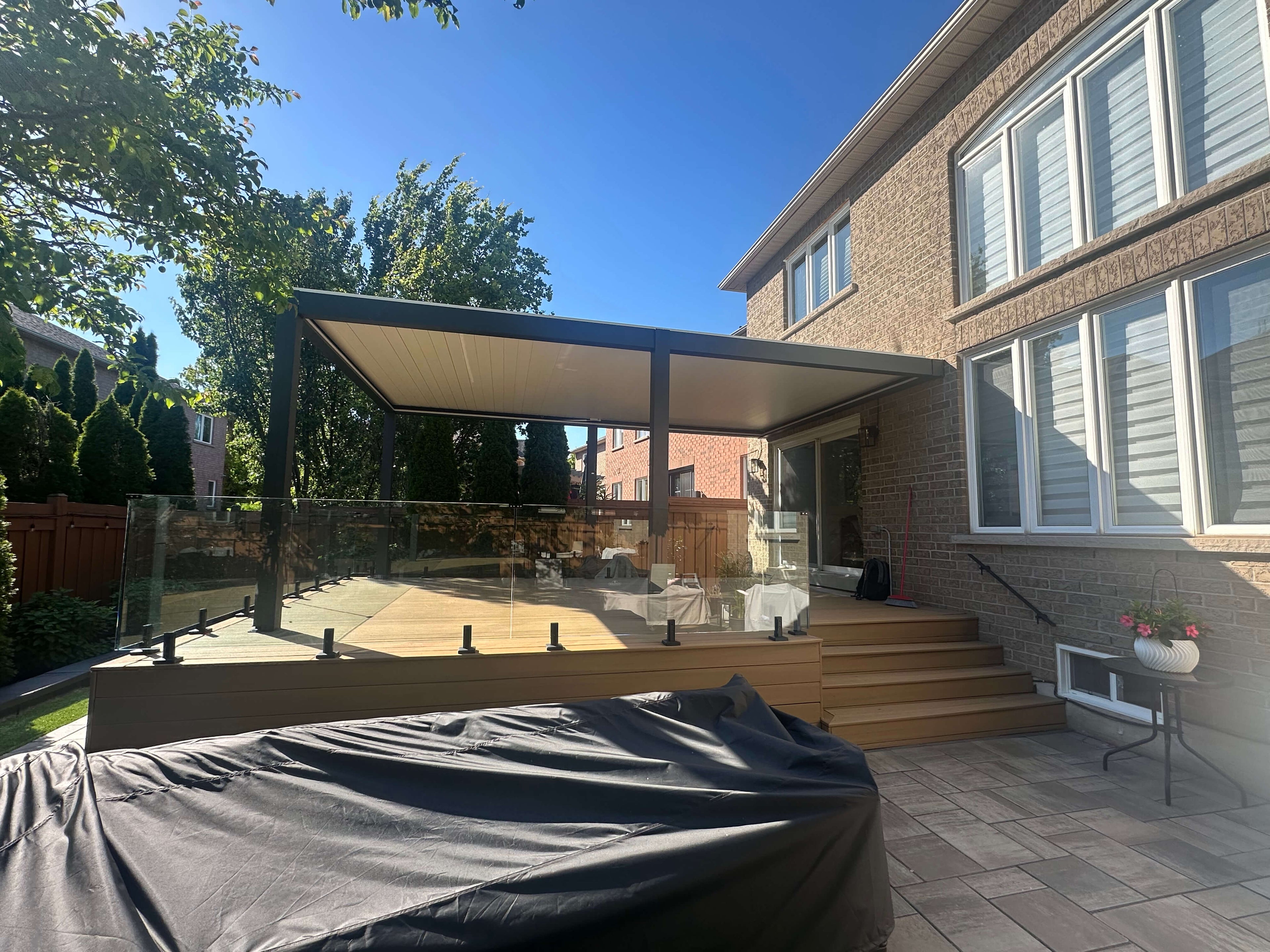 Wall-mounted pergola over a stone terrace