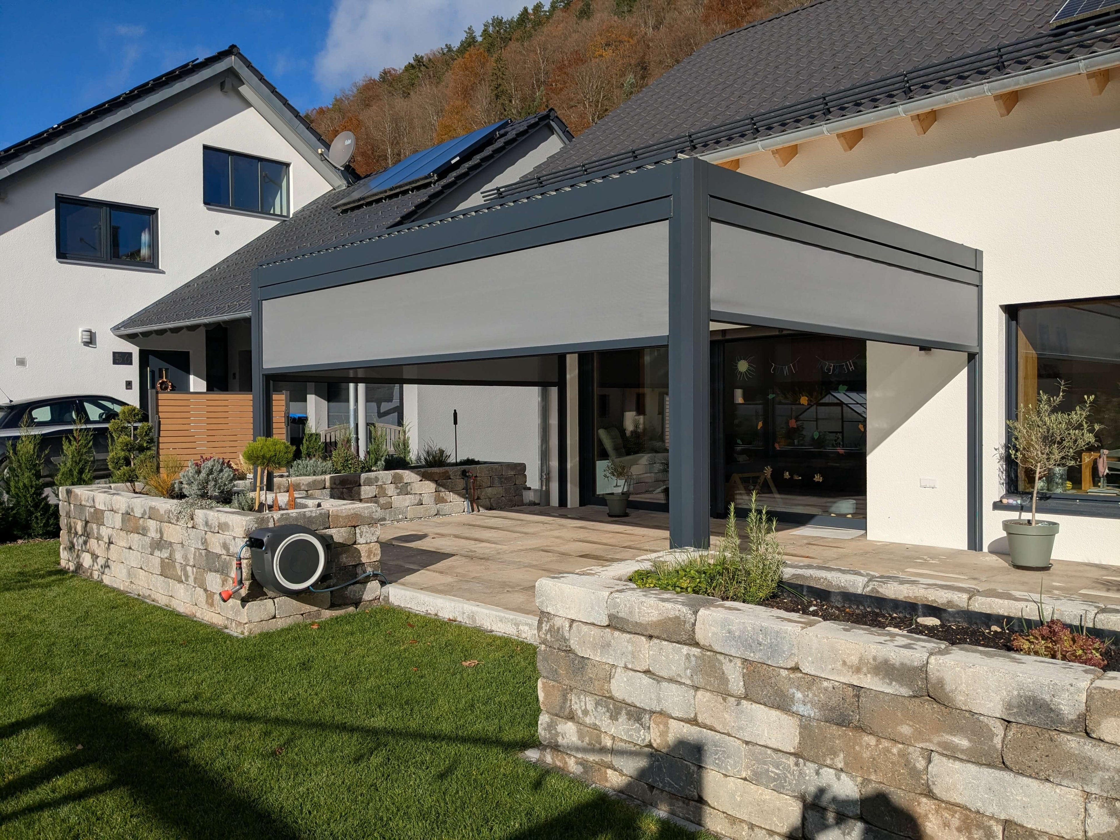 Large anthracite pergola in a landscaped garden