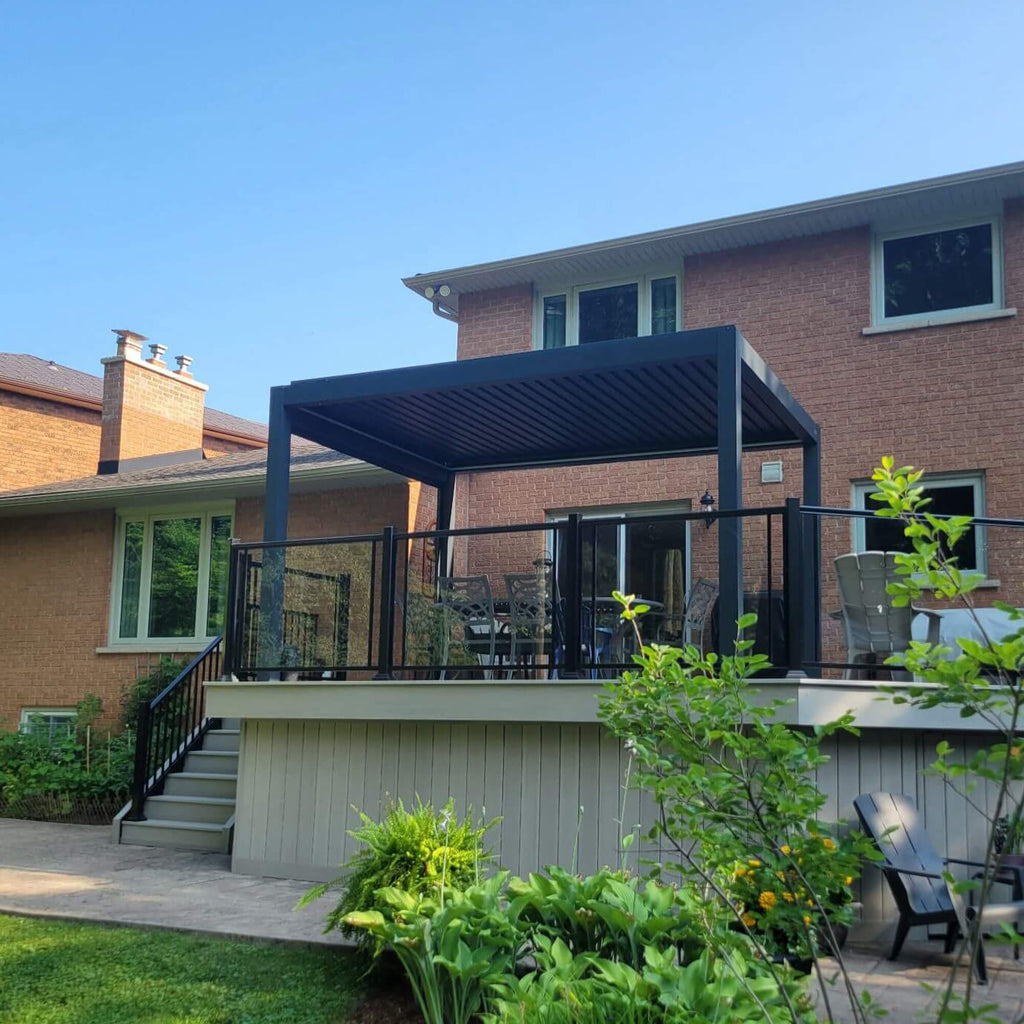 Manual louvered pergola installed over a raised backyard deck