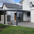 Anthracite manual louvered pergola on a backyard terrace