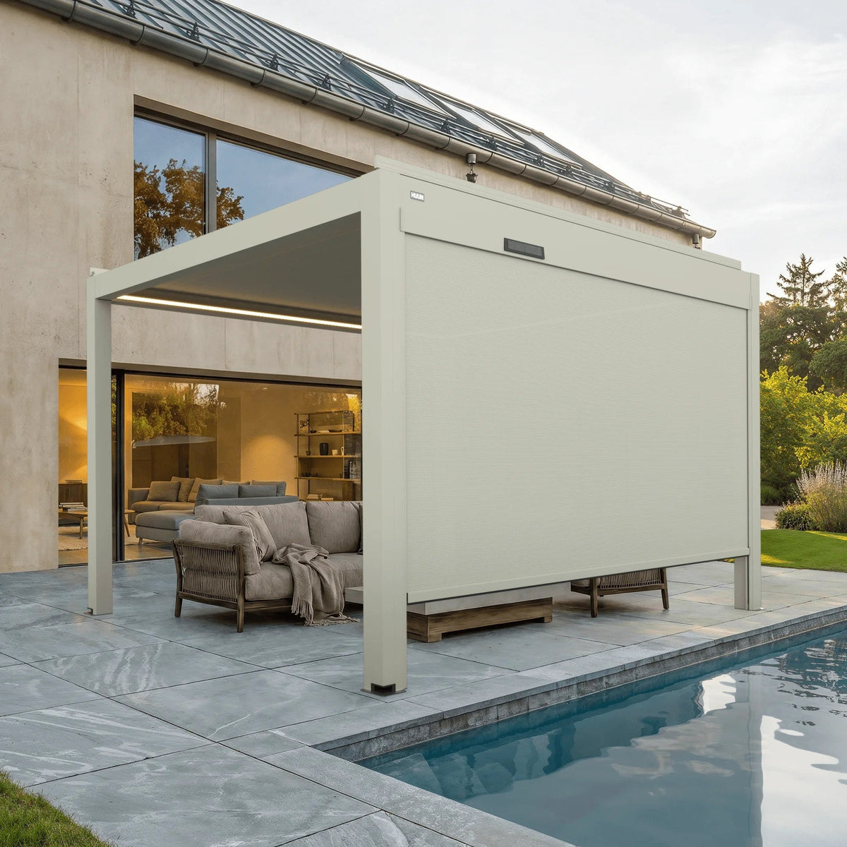 Solar powered side screen on an Equa louvered pergola beside a pool